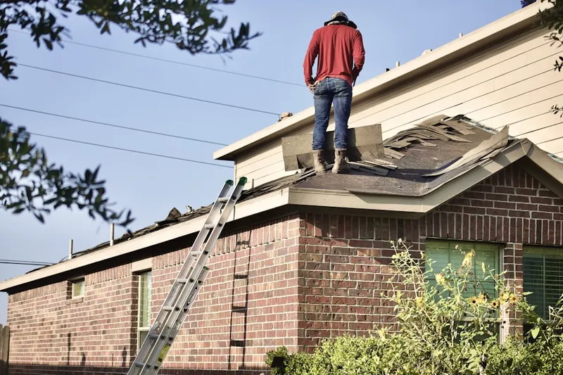 Professional roofer working on a residential roof in Hoods Mill